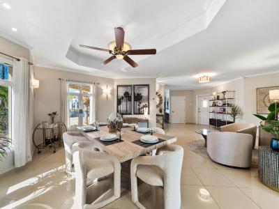 - This dining area features a chic table that comfortably seats six - A stylish ceiling fan and elegant decor that invites relaxation and social gatherings - The space seamlessly connects to the living room, creating a cozy, open environment