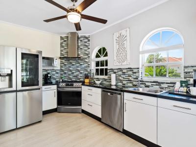 Cook up a storm in a fully equipped kitchen, perfect for gourmet meals and family feasts - Discover the joy of home-cooked meals in a kitchen with stainless steel appliances - Featuring sleek countertops and plenty of storage