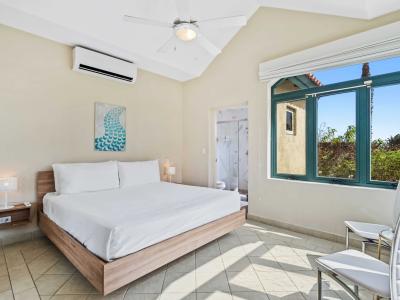 Spacious bedroom with a comfortable king-size bed, offering a restful sleep experience - Large windows allow plenty of natural light, creating a bright and airy atmosphere - Modern decor and amenities ensure a comfortable and relaxing stay