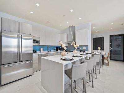 - A well equipped kitchen with modern stainless steel appliances, perfect for meal prep - The large island provides plenty of room for dining or entertaining guests - Clean, contemporary design, perfect for socializing and enjoying meals