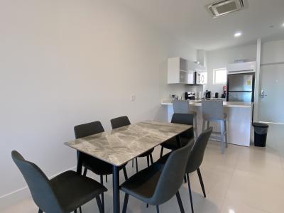 Prepare meals in this bright & stylish kitchen featuring stainless steel appliances - Convenient island with seating makes this space perfect for casual dining or a quick coffee - Designed for functionality & comfort, it's a home away from home