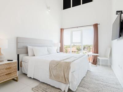 Bedroom 1 features a queen size bed and plenty of natural light from the big windows