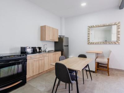 Kitchen with full size fridge and oven and a dining table for two