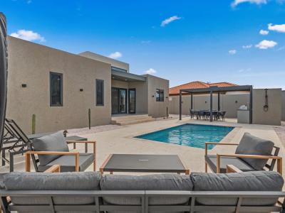 Backyard retreat with a refreshing pool, perfect for sunny days in Aruba - Relax in outdoor seating or dine under the covered pergola with a built-in BBQ - Experience a peaceful escape just minutes from beaches, dining & island adventures