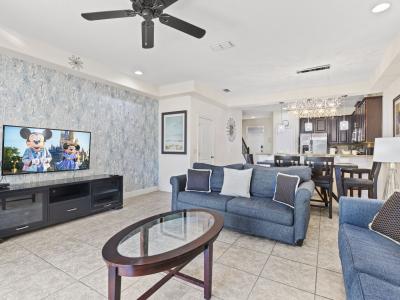 Spacious and sunlit living area featuring plush seating, modern décor, and smart TV—ideal for relaxing after a day of adventure.