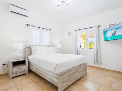 Bedroom 2 features a double size bed and a wall mounted smart TV