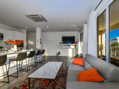 Luxurious living area of the 2BR condo in Noord Aruba - Cosy sofas - Elegantly decored living area - Large bright windows of the living area with Mesmerizing views - Beautifully furnished floor - Availability of TV and Netflix