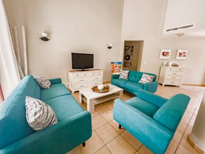 Splendid Living area of the 3BR house in Noord Aruba - Cosy sofas - Wonderful large windows with mesmerising views  - Fabulous sitting with beautifully decored space - Availability of TV and Netflix - Majestic wall lamps