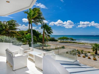 Ostentatious Balcony of the Villa in Noord Aruba - Cozy seating area conducive to relaxation and socializing - Stunning Ocean Views - Greenery Everywhere with palm and tropical tree and plants