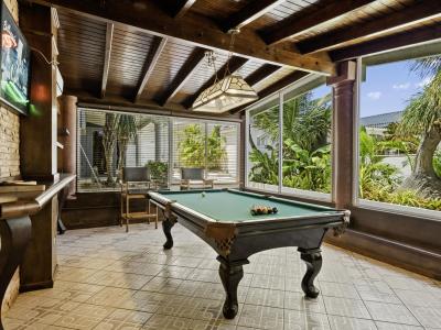 Enjoy a game of pool with a view at our stylish pool table, perfectly positioned to overlook the serene beauty of our backyard oasis.