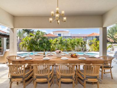 Lavish outside dining area of the Villa in Aruba - 10 Persons Dining - Bite into bliss beneath the stars at outdoor oasis - Elevate your dining experience amidst the beauty of nature - Pool Views