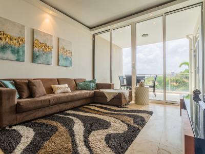 Breathtaking Living Area of the lovely condo in Oranjestad Aruba - Elegantly decorated space with a neutral color palette for a timeless appeal - Private Balcony with outstanding view and cozy sitting - Smart TV and Netflix