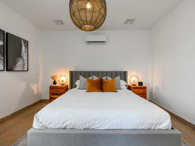 Luxurious bedroom of the villa in Noord, Aruba - Comfy king size bed - Elegantly designed room beautifully decored with large aesthetic wall paintings - Majestic table lamps and elite chandelier - Neat and clean linen with soft pillows