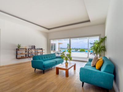 Living area connected to backyard with glass sliding doors