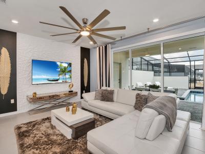 The living room offers a seamless view of the private pool outside, creating a tranquil ambiance that blurs the lines between indoor comfort and outdoor serenity.