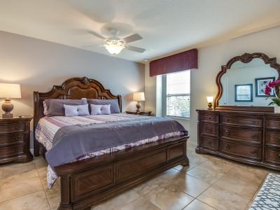 This bedroom, adorned with wooden details and accents, radiates warmth and serenity, inviting you to unwind in a cozy retreat where nature's embrace meets modern comfort.