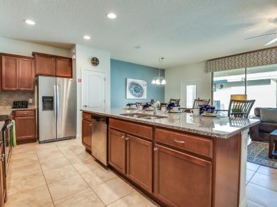 The kitchen with its coveted bar counter becomes a central gathering place, where culinary creations meet lively conversations, fostering connections and culinary adventures alike.