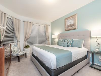 Spectacular bedroom of the home in Kissimmee, Florida - Serene double bed with elegant side lamps - Spacious windows allow natural light, enhancing the room with fresh and open ambiance