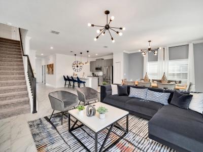 Bright living area of the townhouse in Kissimmee Florida - Open layout seamlessly connecting the living area to the kitchen and dining area - Stylish, contemporary furnishings enhancing the aesthetic - Entertainment hub with a Smart TV