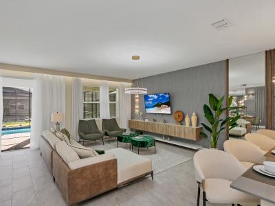 Enchanting living area of the home in Kissimmee Florida - Stylish furniture arrangement providing comfort and a cohesive look - Cozy seating area conducive to relaxation and socializing - Chic and contemporary design elements and a smart TV