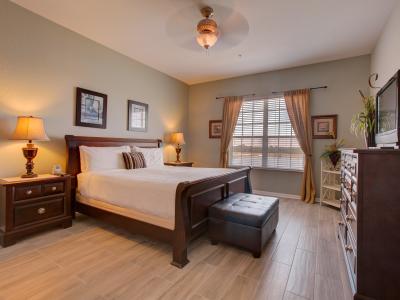 Embrace rustic elegance in this bedroom adorned with wooden furnitures– where natural charm meets timeless style, creating a cozy retreat for rest and relaxation.