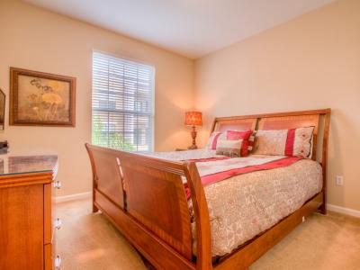 Deluxe Bedroom of the Apartment in Orlando Florida - Full King Size Bed - Minimalist decor, creating a clean and uncluttered sleeping space - Cozy retreat with a plush bed, perfect for relaxation - Soft, lighting for a tranquil mood