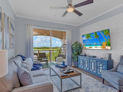 Sunny living room with big 75" smart TV.