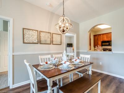 Timeless Elegance: Gather in the Dining Area, Adorned with a Harmonious Blend of Wood and White Details, Creating a Charming Ambiance for Memorable Meals.