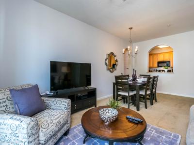 Calming living area of the condo in Orlando Florida - A living room that effortlessly combines sophistication, comfort, and functionality - Smart TV for entertainment - Thoughtful lighting design creates a warm and inviting ambiance