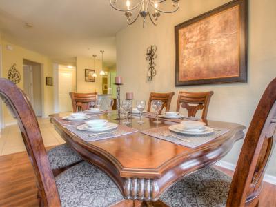 Gather around at our stylish dining area of the condo in Orlando. - A centerpiece for delicious meals and meaningful conversations. - Create lasting memories with your loved ones while enjoying your meals in the heart of this spacious condo.