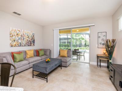 Welcoming living area of the home in Davenport Florida - Stylish furniture arrangement providing comfort and a cohesive look - Cozy seating area conducive to relaxation and socializing - Easy access to outdoors with seating