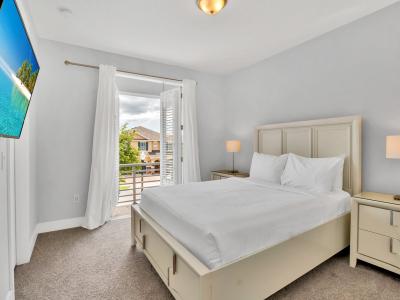 Resplendent Bedroom of the Apartment in Kissimmee Florida - King Size comfy bed - Plush bedding and pillows for a luxurious feel - Smart TV and Netflix - Spacious layout offering a sense of openness - Private Balcony