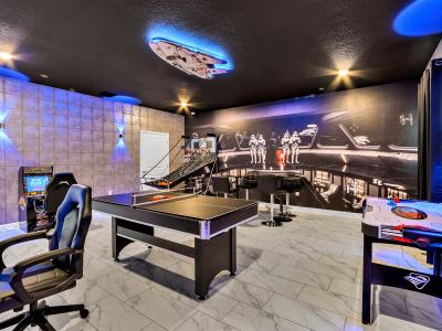 If you are looking for a good time, then look no further because this contemporary game room featuring an arcade game and table games is the perfect place to engage in friendly competition with your family and friends.