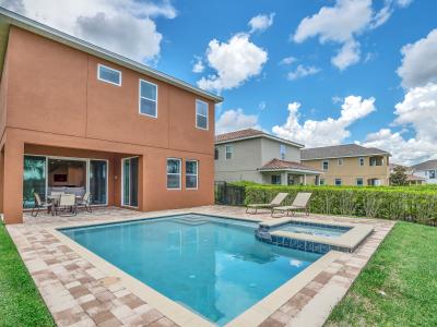 Stunning Outdoor Pool of the Home in Kissimmee Florida - Crystal-clear pool for refreshing dips - Sleek and stylish pool deck design - Greenery for a secluded feel