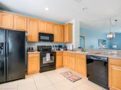 Welcome to the honey kitchen area of our Orlando, Florida apartment, where integrated appliances create a seamless and stylish appearance. The elegant and coordinated color palette ensures a cohesive look throughout.