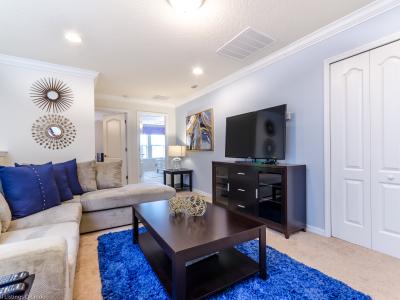 Step into the spacious living room, where relaxation meets entertainment with a prominent TV setup. A haven of comfort and leisure, promising ample space for shared moments and cinematic adventures.