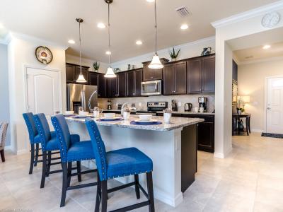 The large, fully equipped kitchen offers an engaging spot to gather for family dinners, boasting updated appliances and granite countertops. It's a contemporary culinary haven where every meal becomes a shared experience.