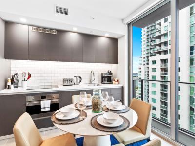 Seamless Elegance: Revel in the harmonious design of your dining area, seamlessly connected to an open kitchen, creating a space where relaxation meets culinary creativity, all against the backdrop of Miami's dynamic scenery. #ElegantLiving #MiamiVib