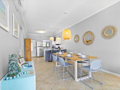 Charming Kitchen and Dining Area with large windows throughout