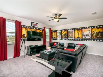 Lush entertainment room of the villa in Kissimmee Florida - Entertainment center for movie nights - Plush sofas to relax and watch your favorite movies and shows - Create unforgettable memories with loved ones