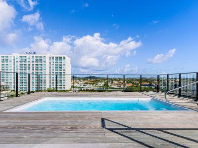 Take a refreshing plunge in our rooftop swimming pool, where relaxation meets panoramic views.